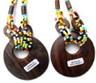 Fun colored necklace holding wooden oval pendant with circle cut out in center