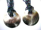 Beautiful balinese multi string beaded necklace with round sea shell pendant 
