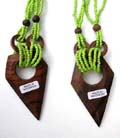 Diamond shaped wooden pendant hanging from lime green bead necklace