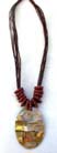 Iridescent oval pendant on multi string necklace with twisted red beads at base 