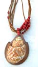 Spiral seashell pendant on multi brown cord necklace with red beads 