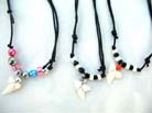 Summer style sea shell charm on black cord necklace with beads at base 