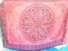 Circular celtic flower emblem in center of designed band frame on batik shawl