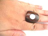 Large, rounded wooden ring with sea shell inlaid in center